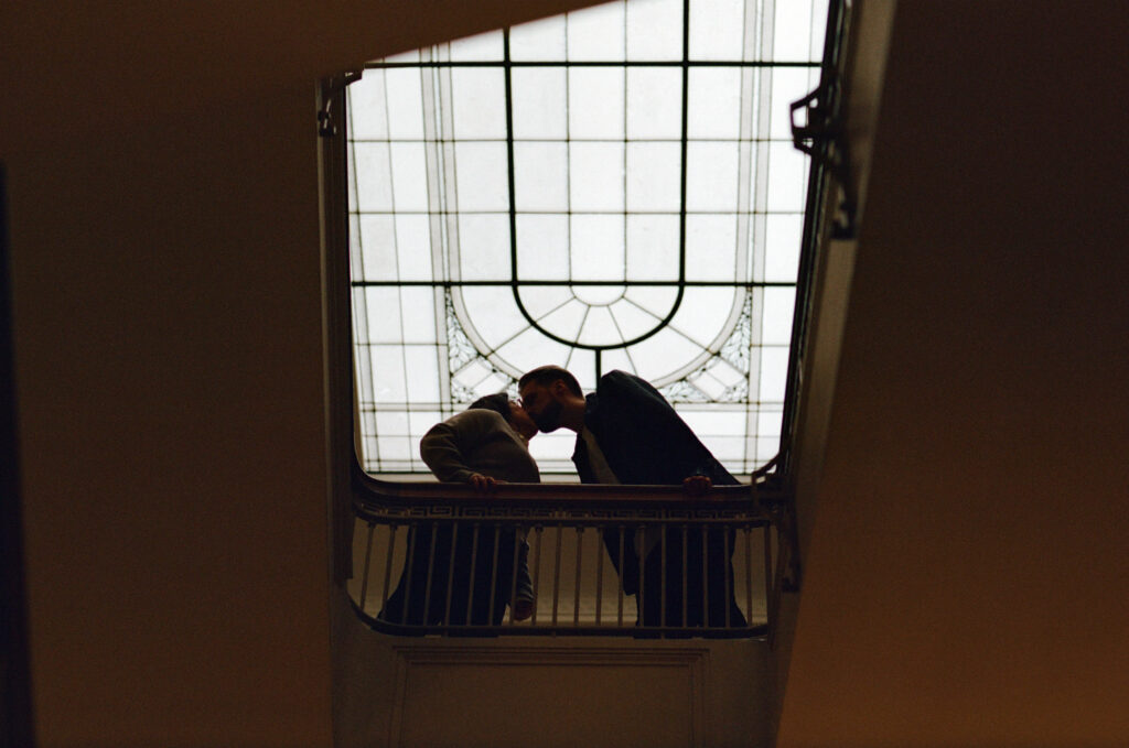 Candid engagement photography inside a Portland library with bookshelves