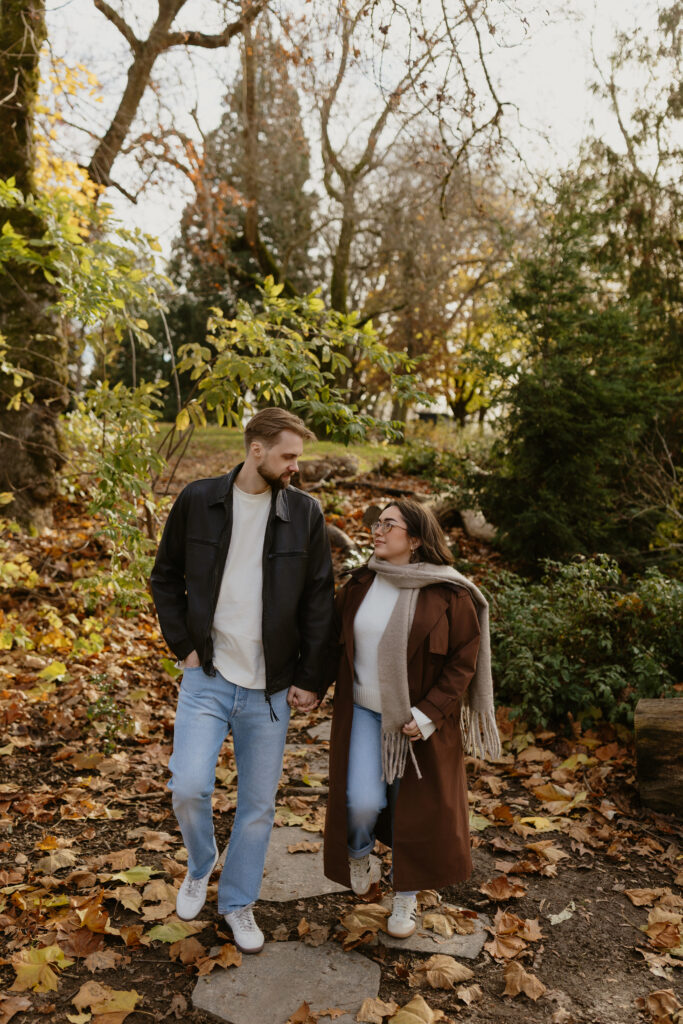 Portland engagement photographer capturing a couple walking through Irving Park